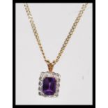 A 14ct gold curb link necklace chain having a hallmarked 9ct gold amethyst and diamond set