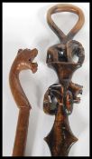 Two vintage walking canes to include a vintage carved African cane carved with Elephant and Tiger