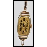 A stamped 9ct gold early 20th Century Art Deco cocktail watch having a rectangular face with a