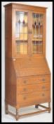 A 20th Century Arts and Crafts oak bureau bookcase, twin glazed doors with lead lined coloured