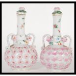 A pair of 19th Century continental porcelain German bottle vases complete with covers or lids. The