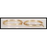 Two vintage hallmarked 9ct gold bangle bracelets one having rounded edges with hidden clasp and