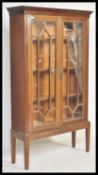 An early 20th Century mahogany Chippendale revival bookcase on stand having twin astragal glazed