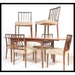 A vintage retro 20th Century teak Danish influence dining table suite with a set of six vintage teak