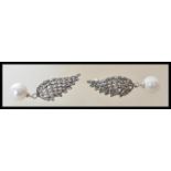 A pair of stamped 925 silver earrings in the form of wings, set with marcasites having pearl drops