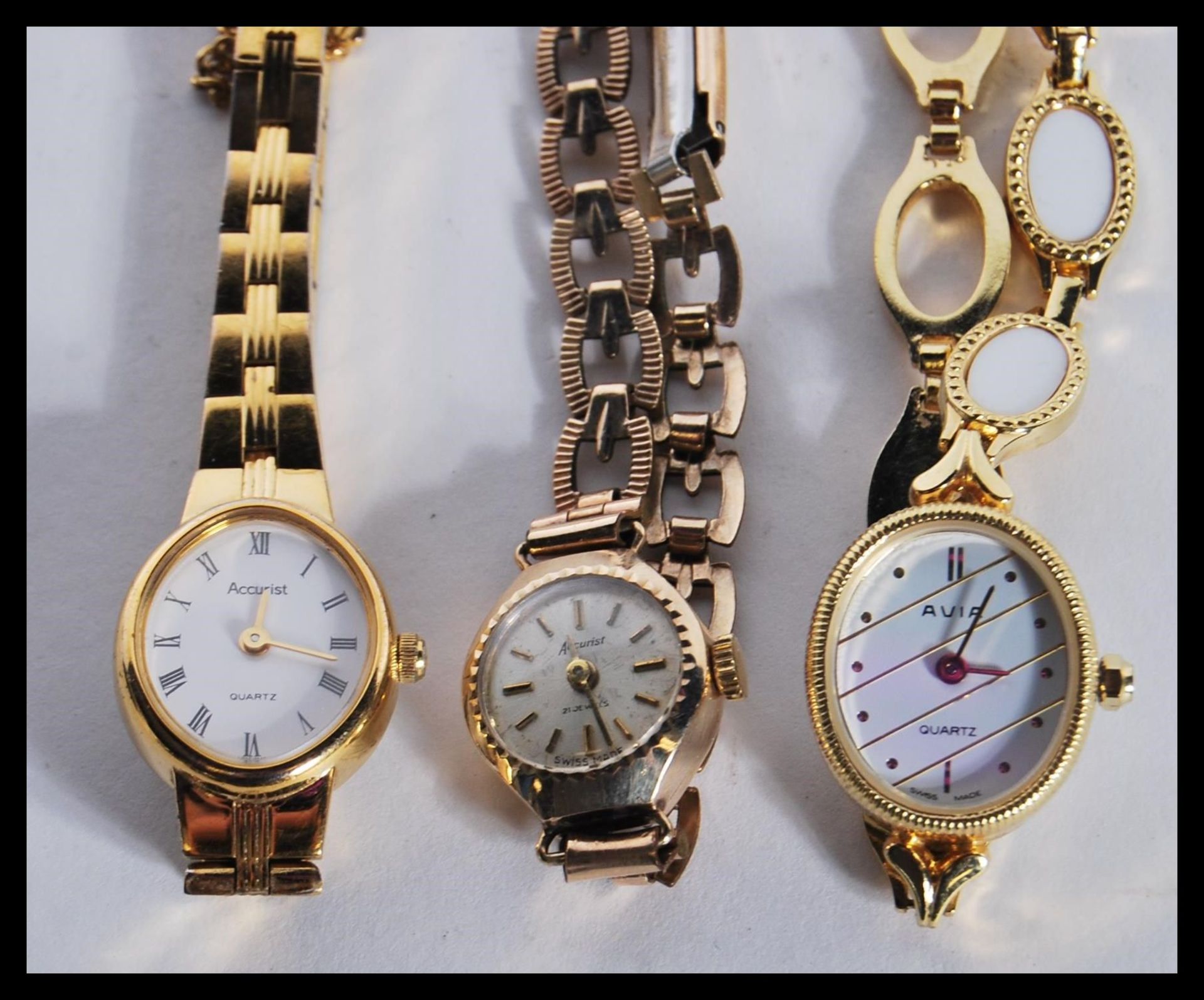 A 9ct gold 375 marked ladies Accurist dress watch set to a rolled gold bracelet strap together