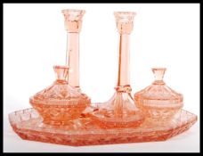 An early 20th Century Art Deco 1930's peach glass dressing table vanity set consisting of