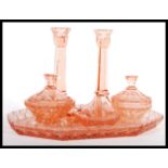 An early 20th Century Art Deco 1930's peach glass dressing table vanity set consisting of