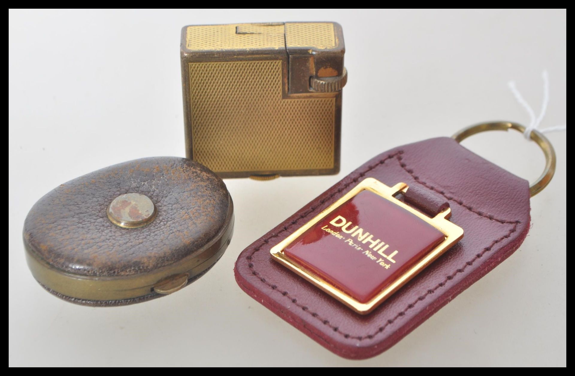 A vintage 20th Century smoking interest Dunhill Monaco cigarette lighter having a gold tone finish