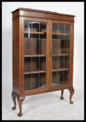 A 1920's oak leaded glass display cabinet bookcase / china vitrine. Raised on cabriole legs with pad