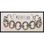 An early 20th Century Art Deco silver and marcasite set bracelet having circular hoop links with