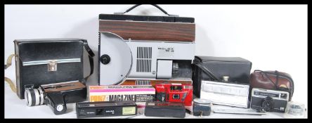 A collection of vintage film cameras and equipment to include a Bolex 18-9 projector, a kodak