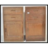 A pair of vintage 20th Century military bedside locker cabinets having a configuration of two