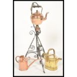 A vintage 20th Century Arts and Crafts copper spirit kettle raised on a wrought Iron stand