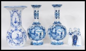 A collection of Delft blue and white ceramics dating from the 19th Century to include two vases