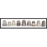 A group of five hallmarked silver thimbles along with silver plated thimbles. Includes Charles