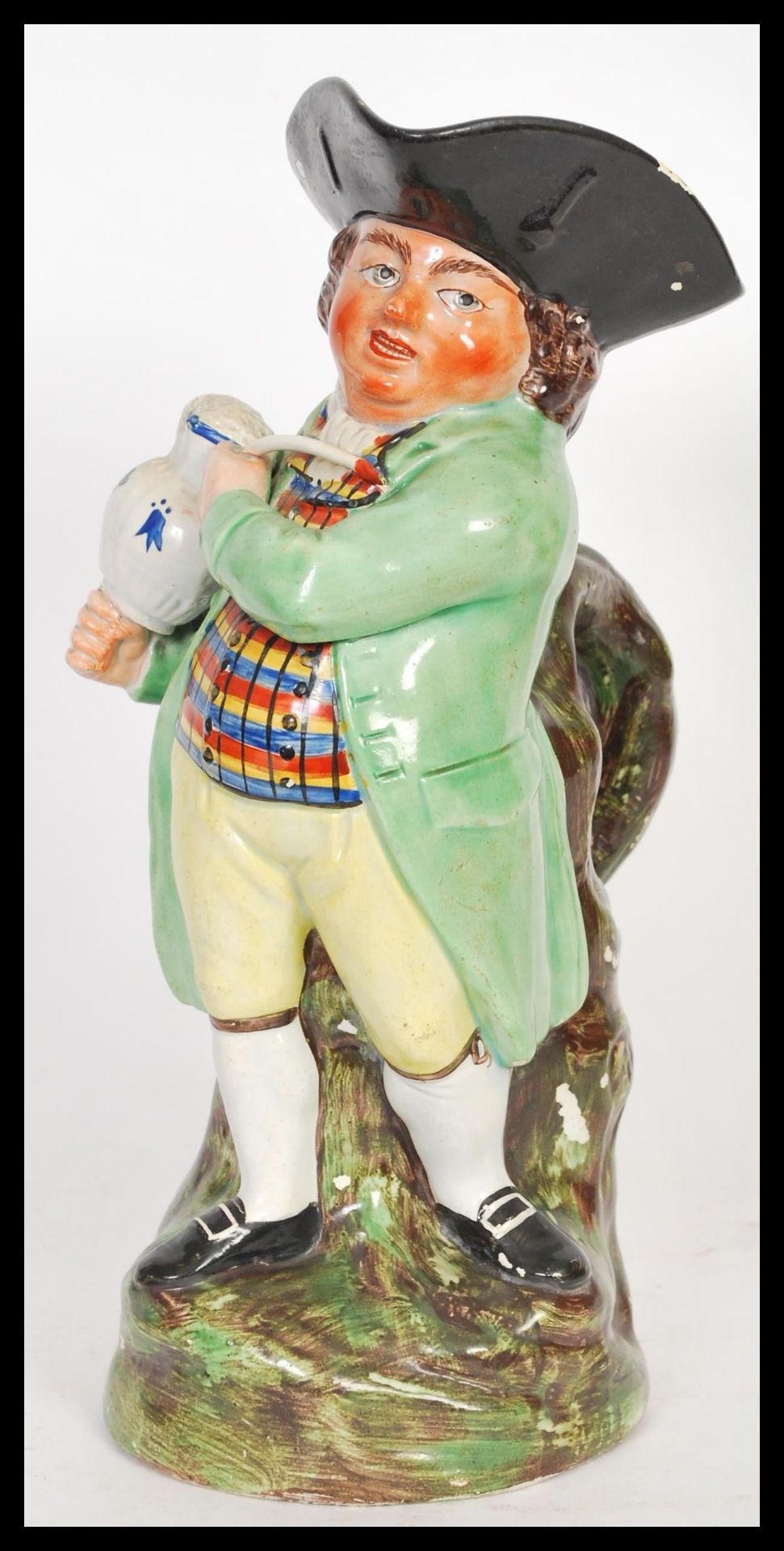 A early 19th Century Staffordshire Toby fillpot jug, the gentleman being dressed in a light green