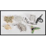 A collection of vintage costume jewellery brooches and rings to include a brooch in the form of a