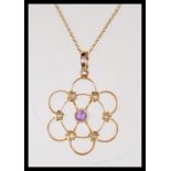 A 19th Century Victorian marked 15ct gold open work pendant in the form of a flower set with seed