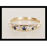 A hallmarked 9ct gold diamond and sapphire ring having flush set blue and white stones. Weighs 2.6