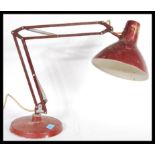 A vintage retro 20th Century 1001 Lamps anglepoise lamp raised on a circular base with conical