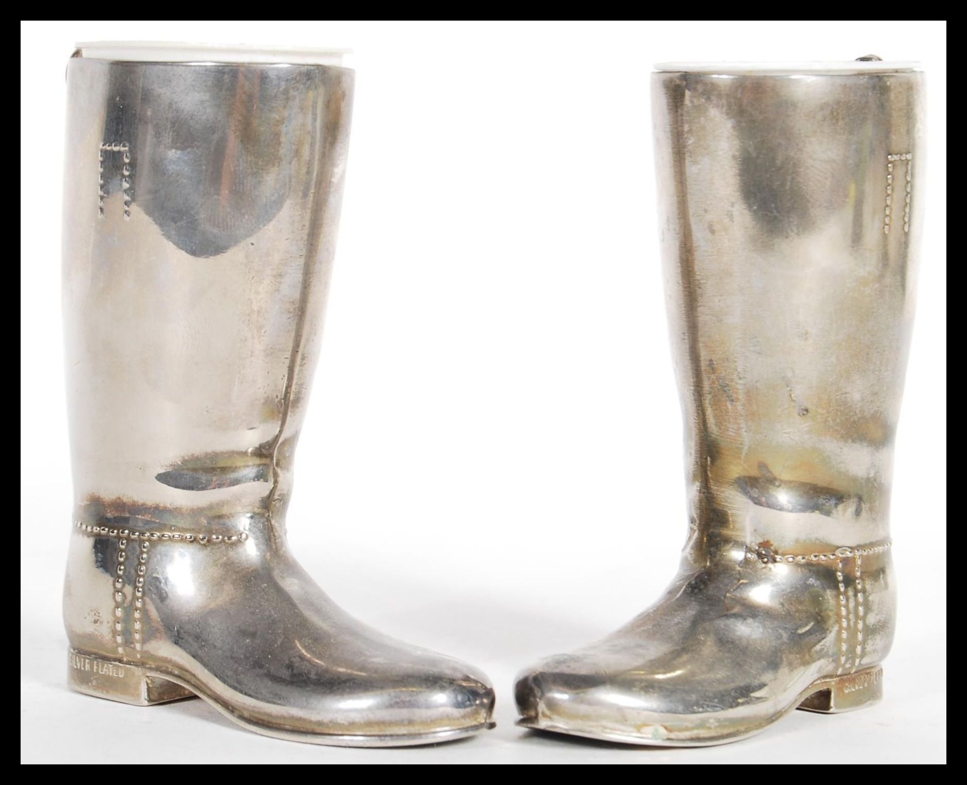 A pair of 20th century silver plated boot measures for spirits. Complete with the white inner
