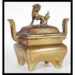 A 19th Century Chinese bronze censer ding incense burner bowl raised on four legs with Fu Dog finial