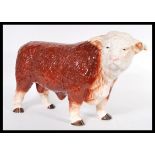 A vintage 20th Century ceramic butchers display figure in the form of a hereford bull, being hand
