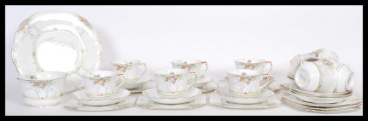 An early 20th Century Art deco bone China hand painted tea service for twelve persons, hand