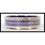 A silver hallmarked Bristol blue glass lined dish, the fret pierced surround with makers marks for