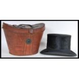 A 19th Century Victorian leather hat box containing the original black moleskin top hat with