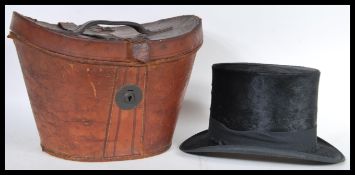 A 19th Century Victorian leather hat box containing the original black moleskin top hat with