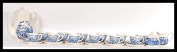 A 20th Century blue and white tea set made by English Ironstone Tableware titled river scenes,