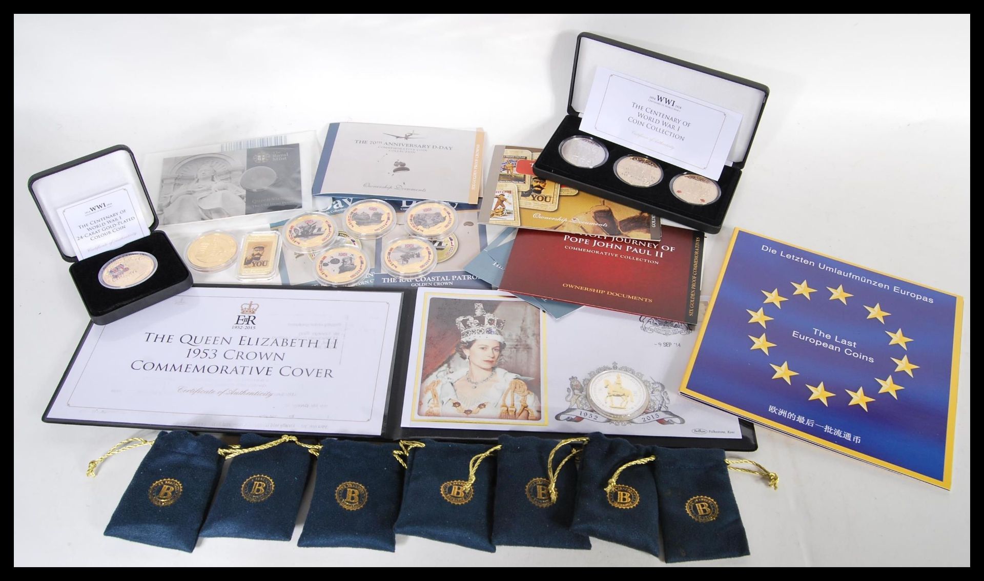 A collection of gold plated commemorative crowns to include five military related coins in coin