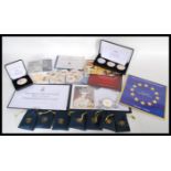 A collection of gold plated commemorative crowns to include five military related coins in coin