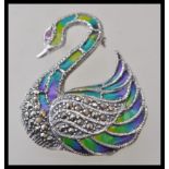 A stamped 925 silver plique a jour brooch in the form of a swan set with marcasites and a red