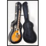 A vintage Aria made Gibson style six string electric guitar having a two tone tobacco sunburst body,