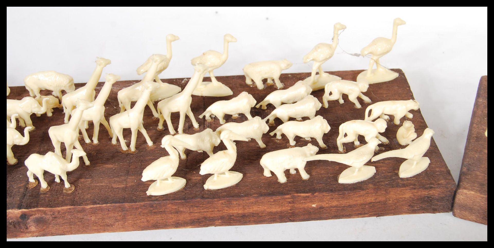 A selection of white faux ivory cast resin figures of animals mounted on a stained wooden base along - Bild 3 aus 5