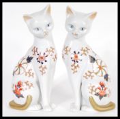 A pair of 20th Century collectable John Jenkins cats in the manner of Crown Derby. The cats modelled