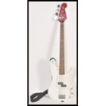 A vintage unknown-make Fender Precision Base style electric bass guitar. White body, with red