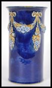 An early 20th Century Royal Doulton stoneware vase of cylindrical form having cobalt decoration with