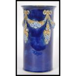 An early 20th Century Royal Doulton stoneware vase of cylindrical form having cobalt decoration with