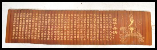 A 20th century Chinese bamboo scroll slip having panels of bamboo inscribed with Chinese