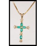 A 9ct gold and emerald cross pendant set to a 9ct gold box linked necklace chain. emeralds approx