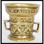 A 16th century style bronze alloy apothecary mortar in the Dutch manner cast to the rim with the