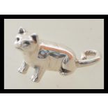 A stamped 925 silver figurine in the form of a cat with a curled tail. Weight 5.8g. Measures