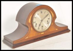 An early 20th Century Napoleon's hat / dome top mahogany mantel clock having box wood inlaid