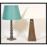 Two vintage retro 20th Century wooden Okra lamps one having a bulbous knopped column and the other