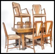 A 20th Century Art Deco walnut large dining suite consisting of dining table and a set of eight