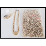 A collection of various vintage 20th Century pearl beads and necklaces to include a bozed lorus